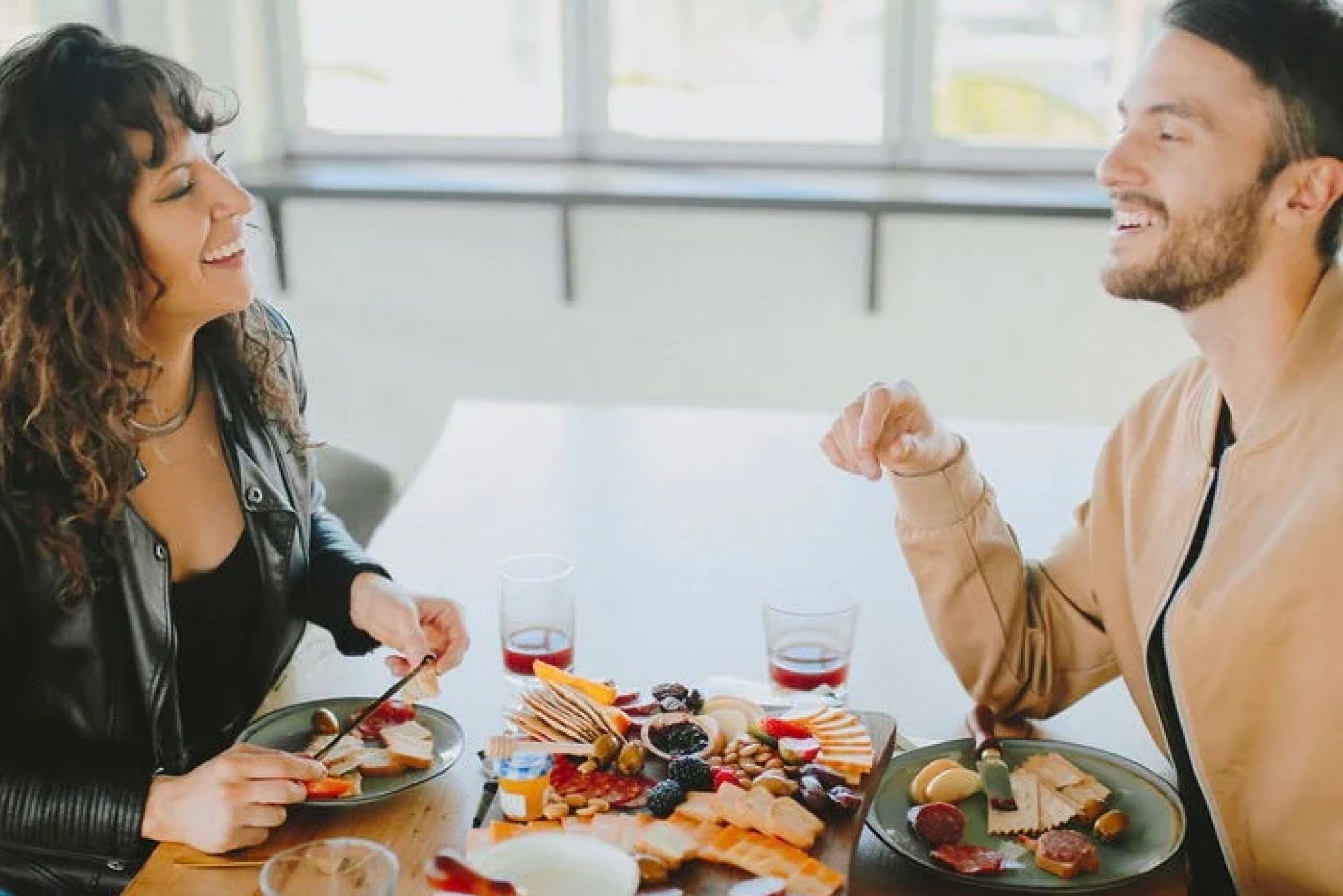 couple of coworkers enjoying a charcuterie board together